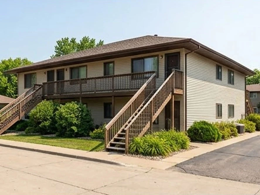 1970s two-story 8-unit apartment building with exterior stairs, summer