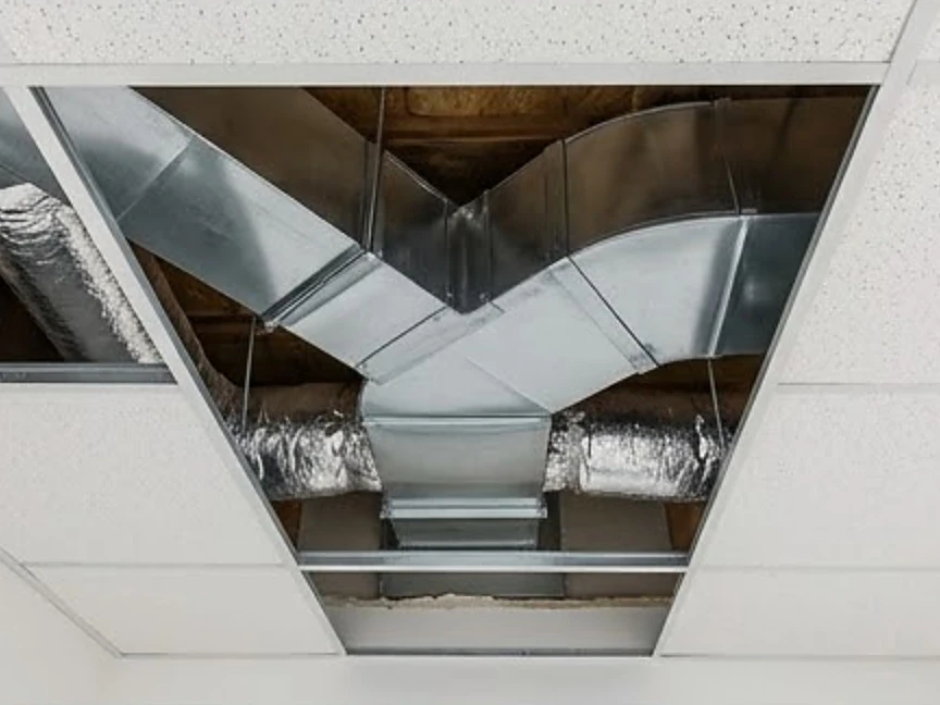 Ductwork above a dropped ceiling with tiles removed, newer