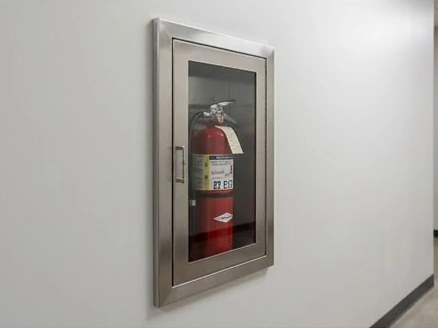 Fire extinguisher in a recessed wall cabinet, newer building