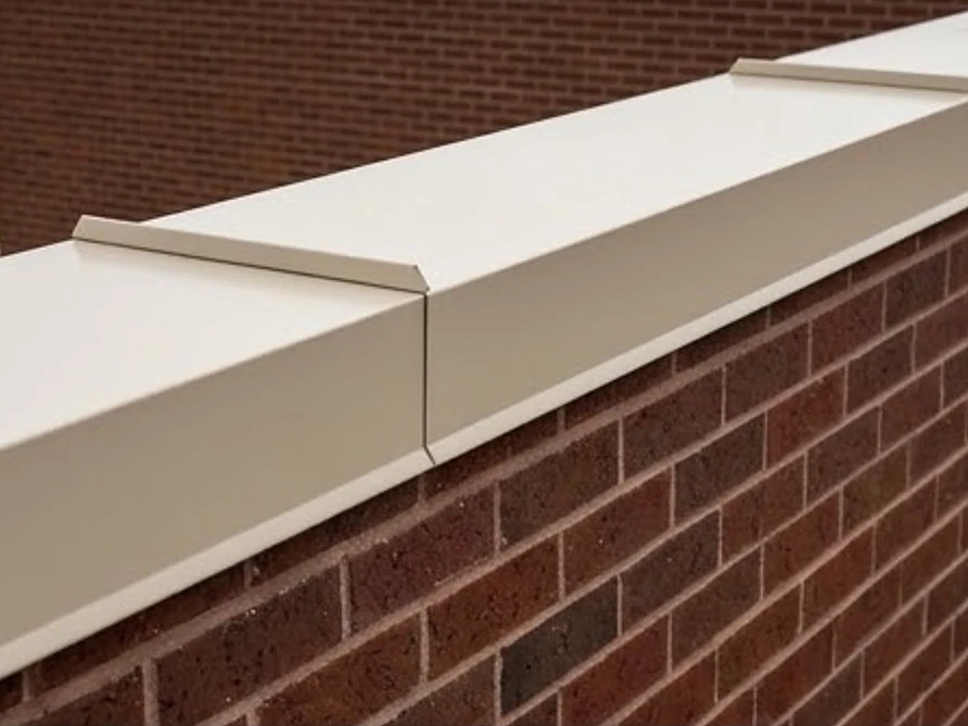 Parapet wall with a metal coping cap, good condition