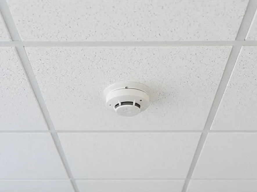 Smoke detector on a commercial ceiling, newer building