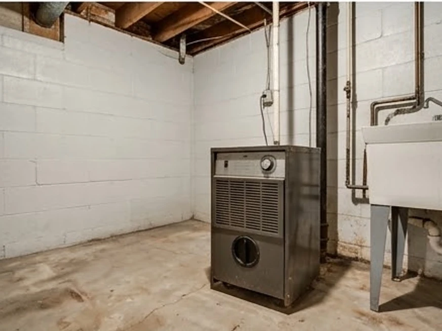 Basement with a dehumidifier running, older basement