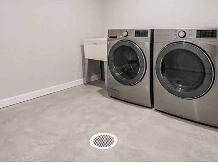 Laundry room with floor drain, newer basement