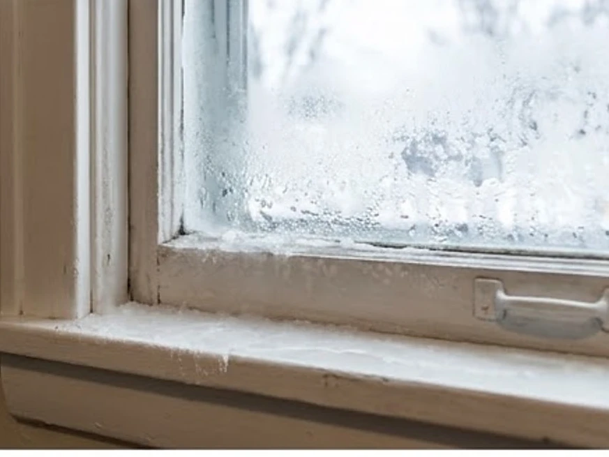 Frost and condensation on a window sill, older home: mold inspection in Edina, MN