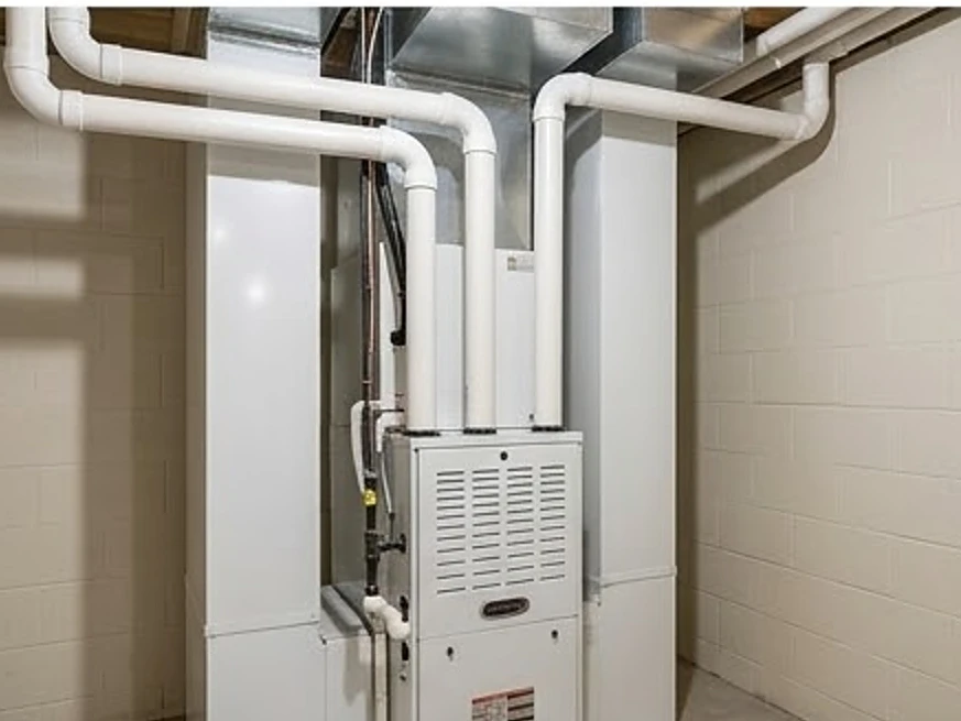 High-efficiency gas furnace with white PVC vent pipes, newer home: hvac inspection in Minnesota and Iowa