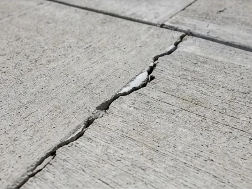 Settled new driveway crack, close-up: 11-month warranty inspection in Delano, MN