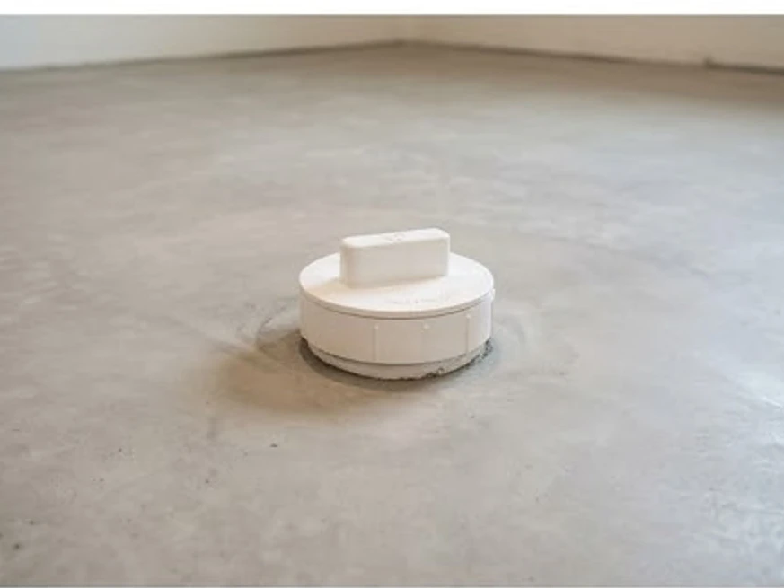 Sewer cleanout cap in a basement floor, newer basement: sewer scope inspection in Osseo, MN