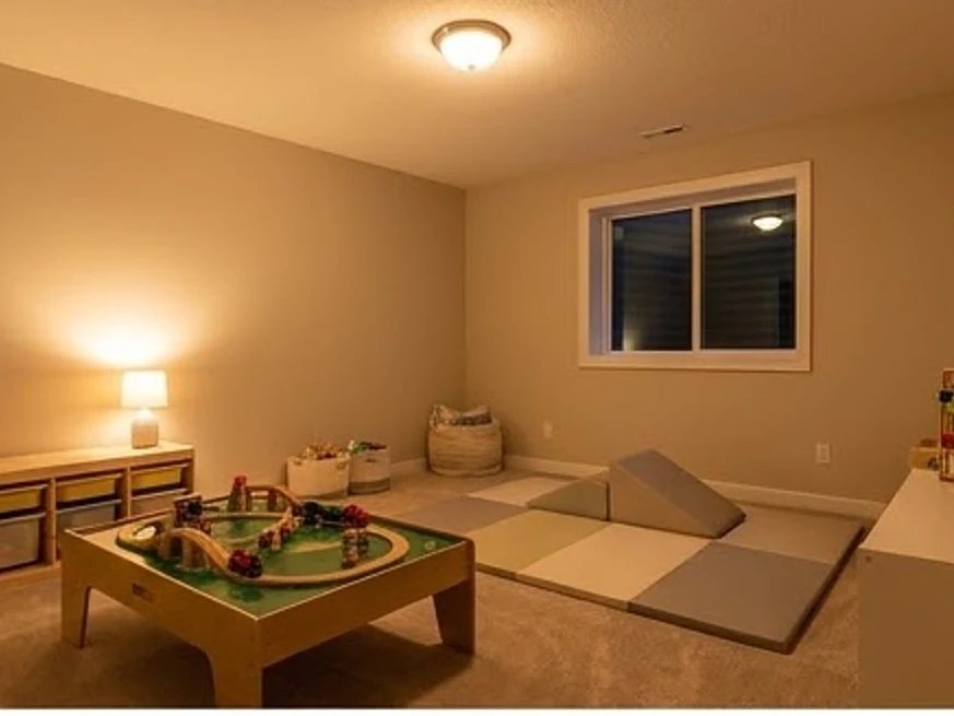 Basement playroom (no people, no toys with text), warm lamp light: radon testing in Inver Grove Heights, MN