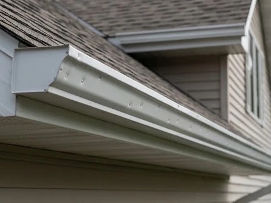 Gutters with hail dents, wider view: roof inspection in Chanhassen, MN
