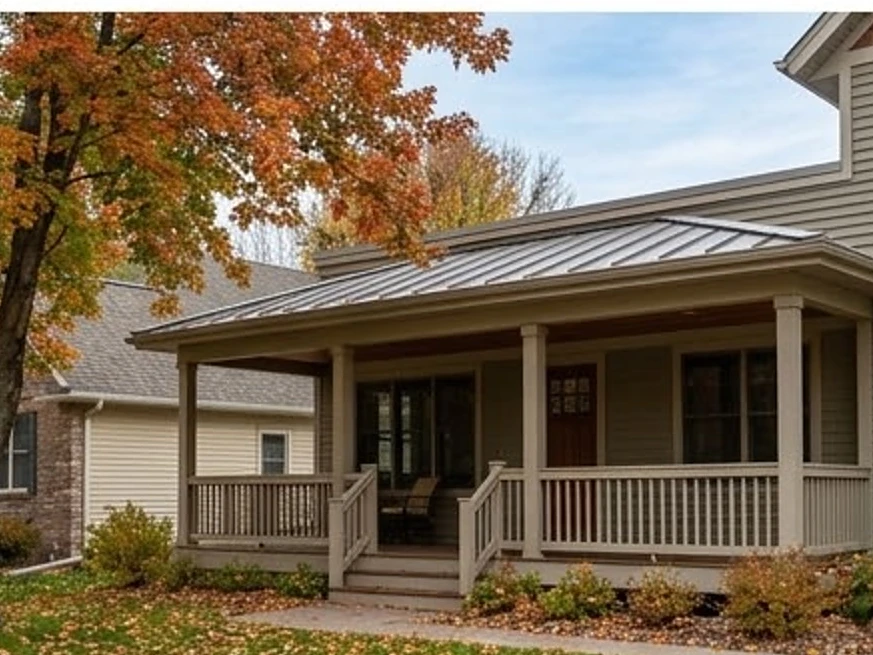Low-slope roof over a porch, autumn: roof inspection in Carver, MN