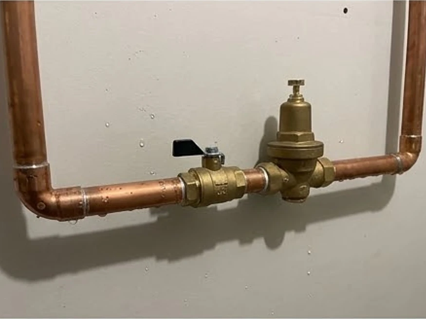 Lakota, IA water testing: copper main water line with shutoff valve in a newer Iowa basement